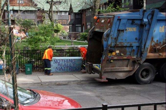 Toronto Mattress Into The Garbage Truck